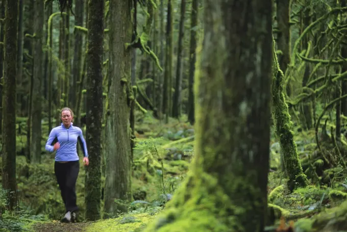 Women trail running in Golden Ears Provincial Park, British Columbia, Canada.