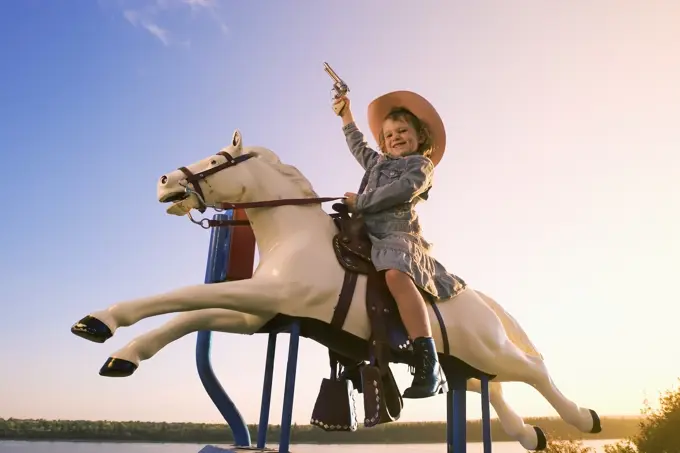 6 year old girl on pony amusement ride, Canada.