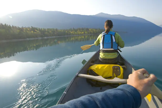 Paddling a canoe on an autumn morning on Chilko Lake, British Columbia