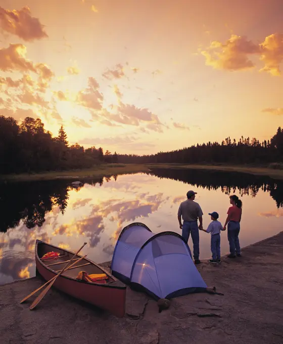 Family camping on riverbank, Whiteshell River, Whiteshell Provincial Park, Manitoba, Canada