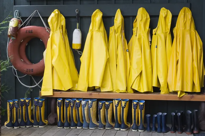 Yellow raincoats and boots outside Middle Beach Lodge, Vancouver Island, British Columbia, Canada.