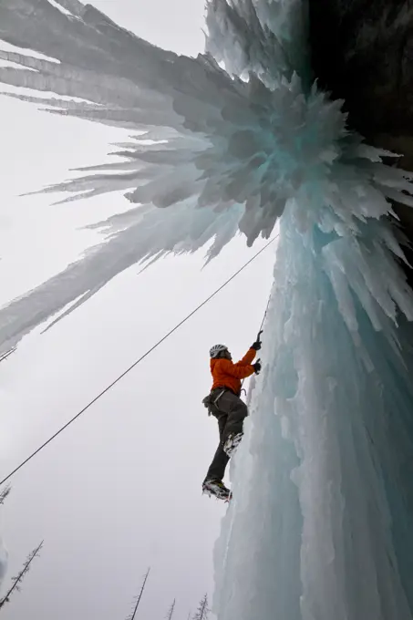 Young man ice_climbing in Banff National Park near Banff, Alberta, Canada.