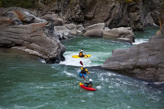 A group of kayakers head into the canyon on the Fraser River, Mt Robson Provinical Park, BC