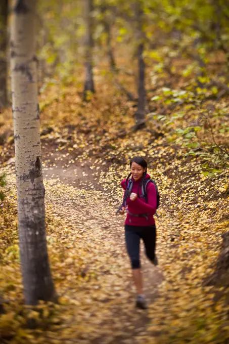 A young, fit woman trail running the Highline trail in Canmore, AB