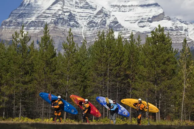 A group of kayakers pose for a photo after kayaking the Fraser River, Mt Robson Provinical Park, BC