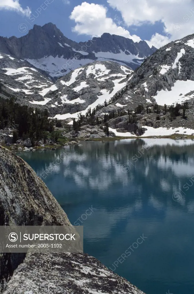 Reflection of a snowcapped mountain in water, Baboon Lake, Californian Sierra Nevada, California, USA