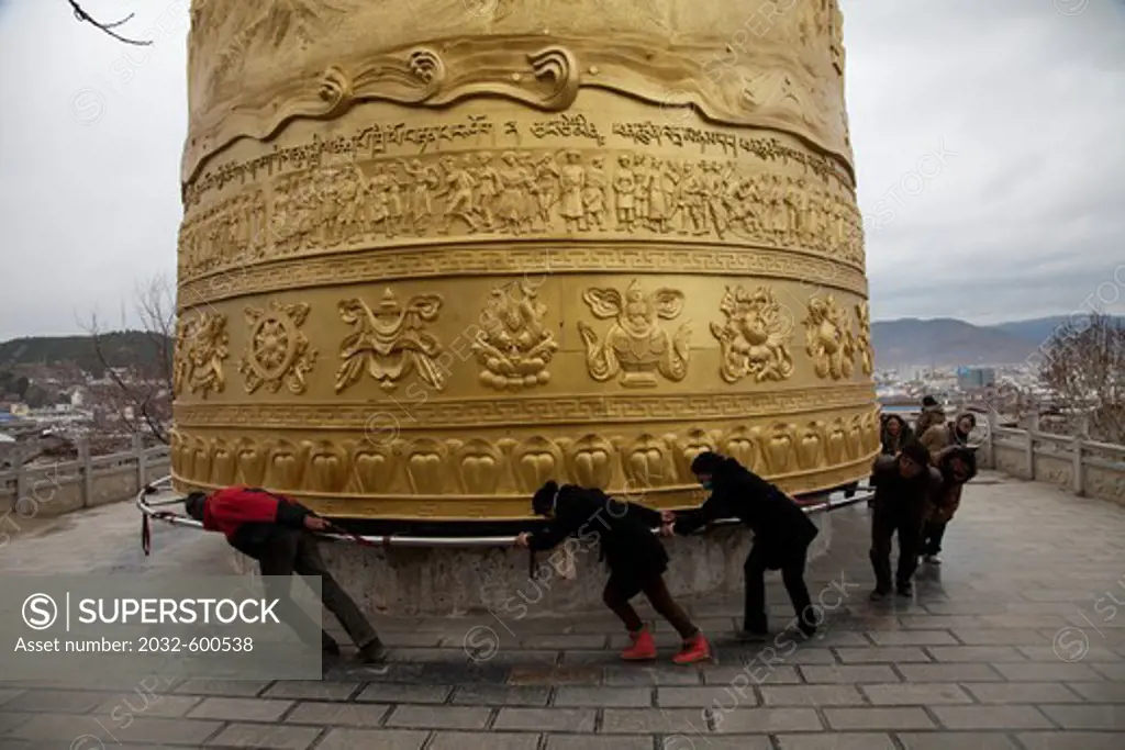 China, Yunnan, Shangrila, Large prayer wheel above old town