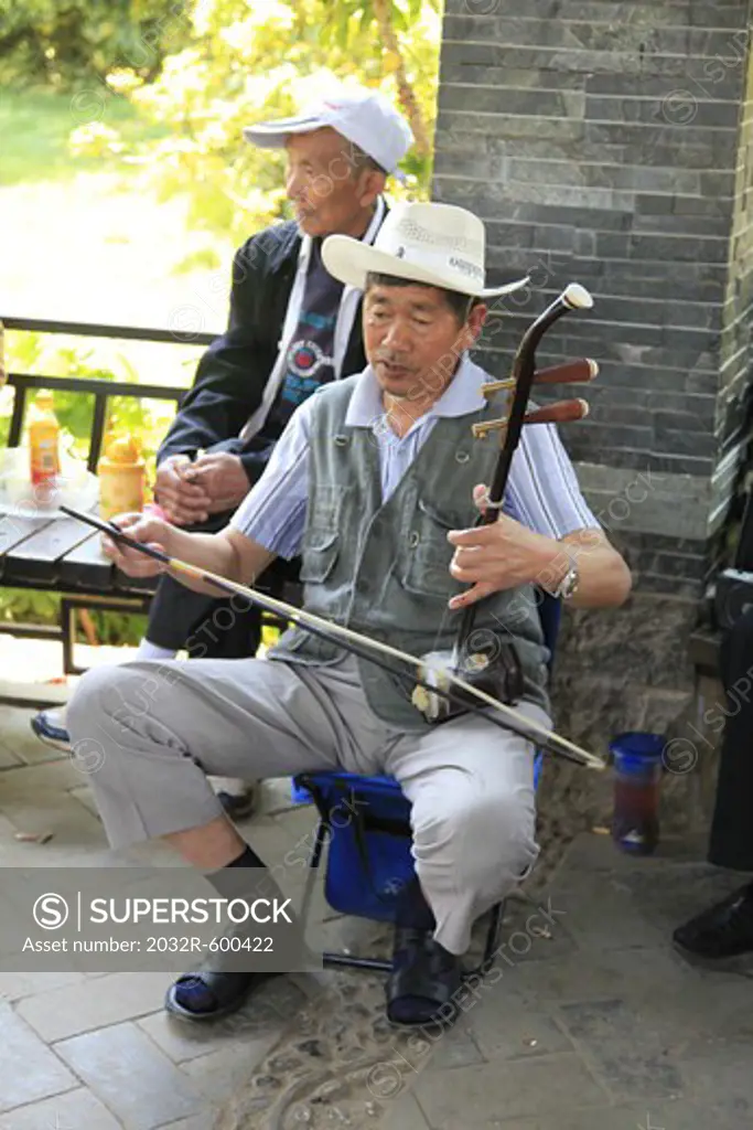 China, Kunming, Man playing erhu