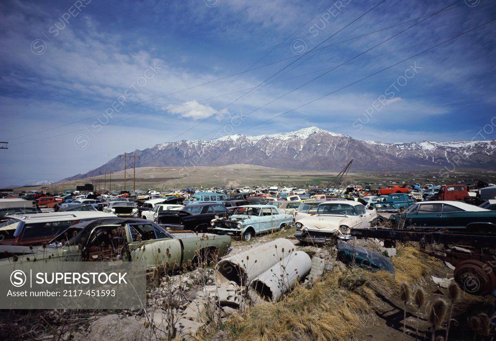 Junkyard with snow covered mountains in the background, Ogden 