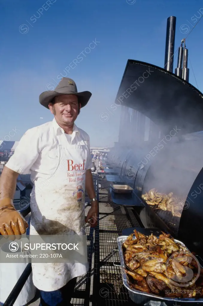 Portrait of a mature man cooking on a barbecue grill, Texas Stadium, Irving, Texas, USA