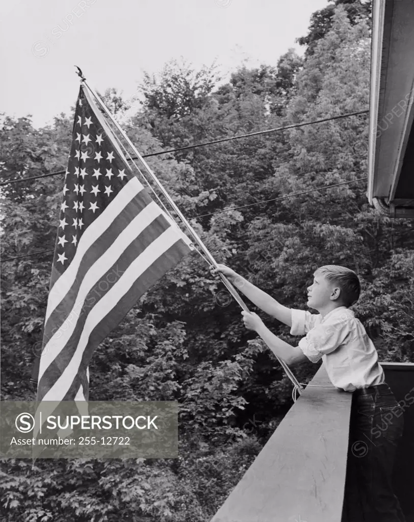 Boy holding an American flag, USA