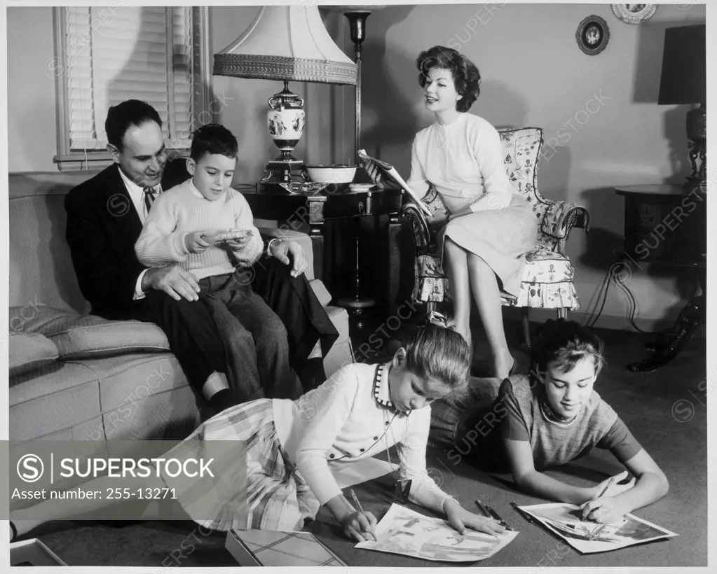 Parents and their children sitting in the living room