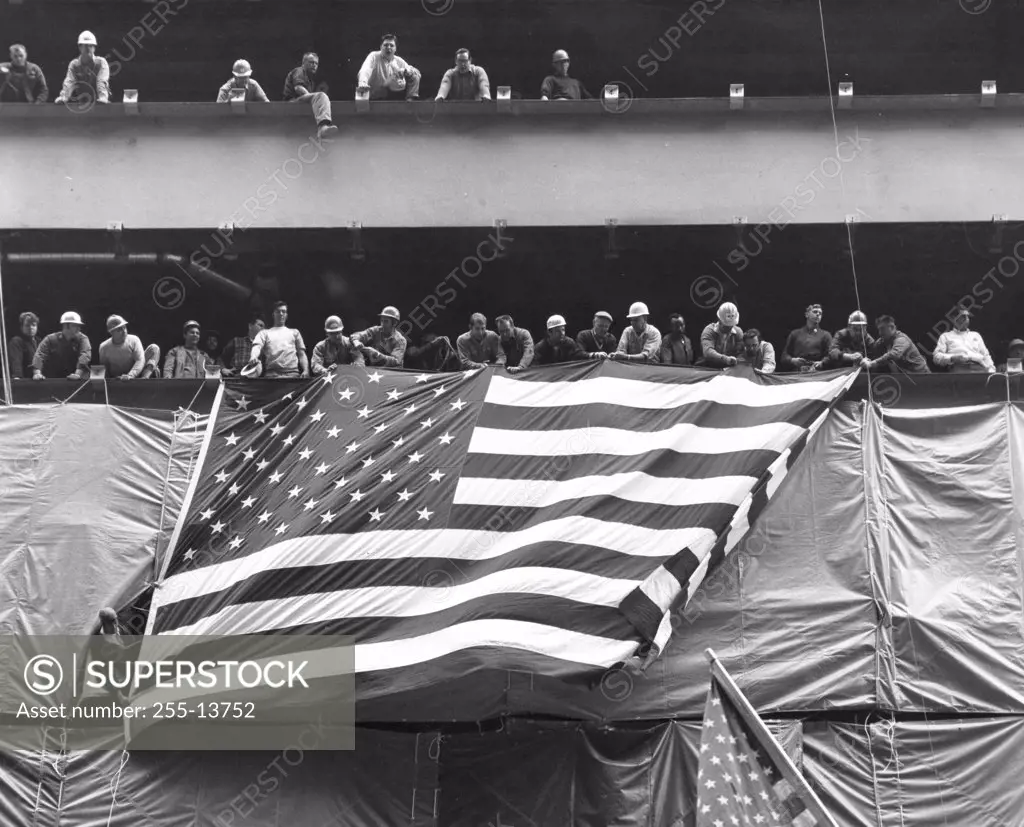 Low angle view of a crowd holding an American flag, USA