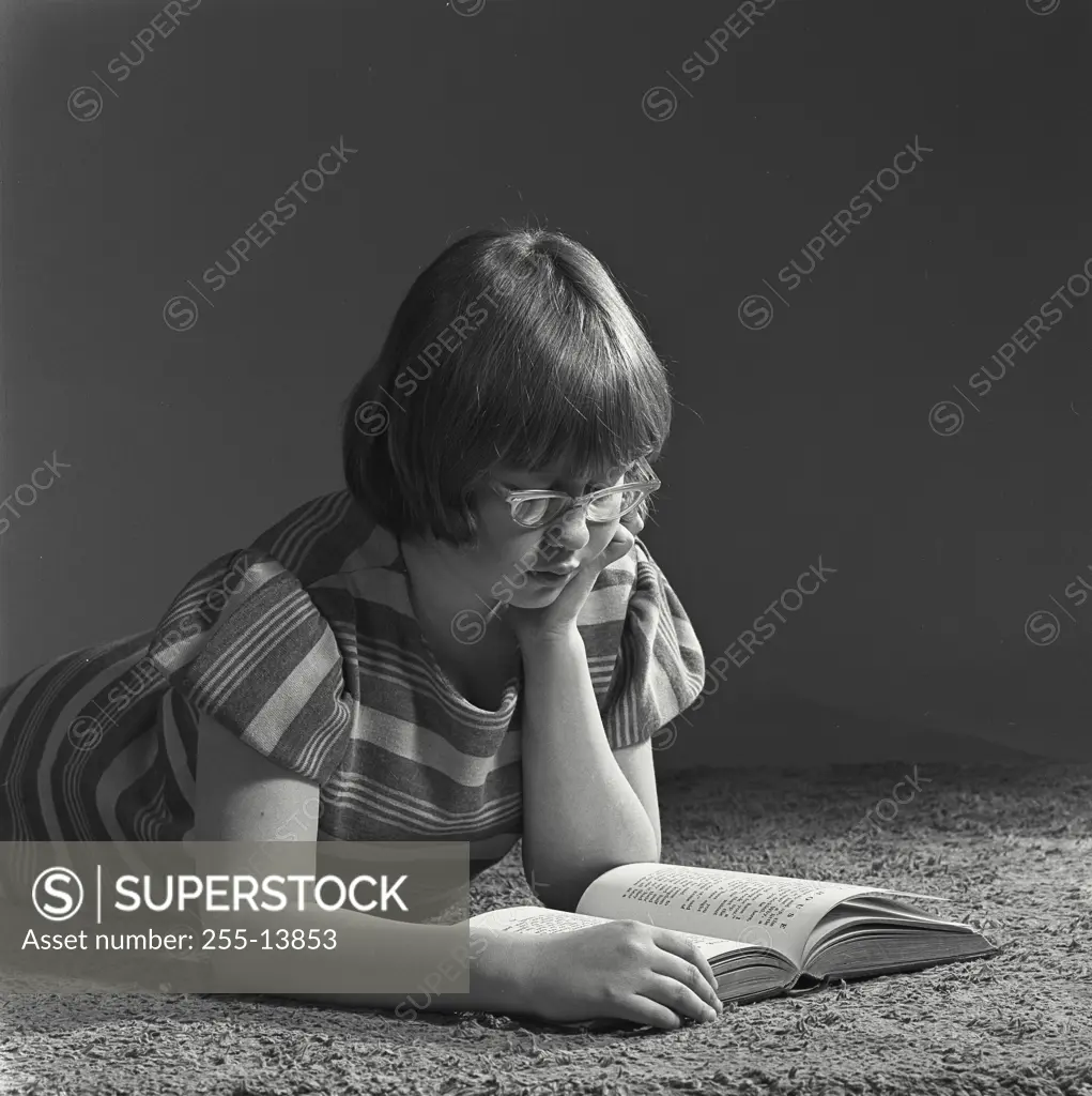 Vintage Photograph. Young girl reading a book. Frame 1