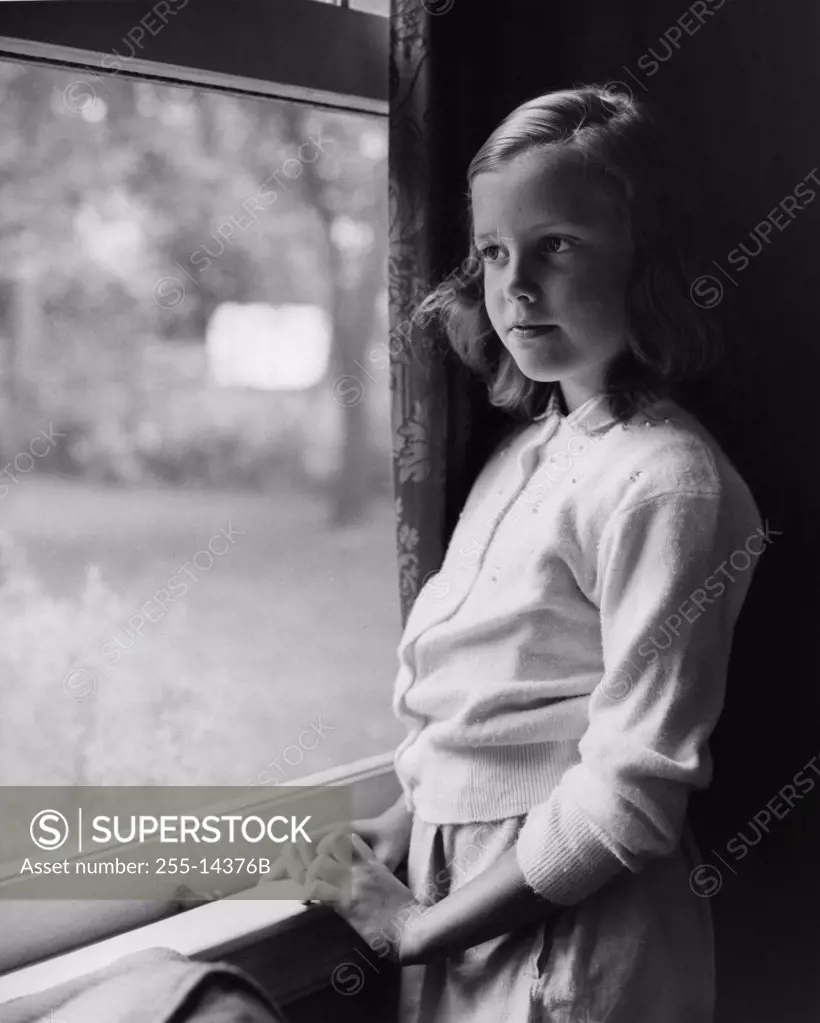 Girl looking out of window