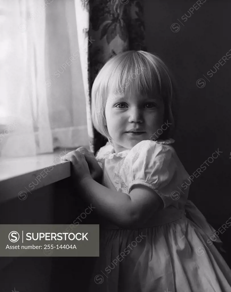 Little girl near window