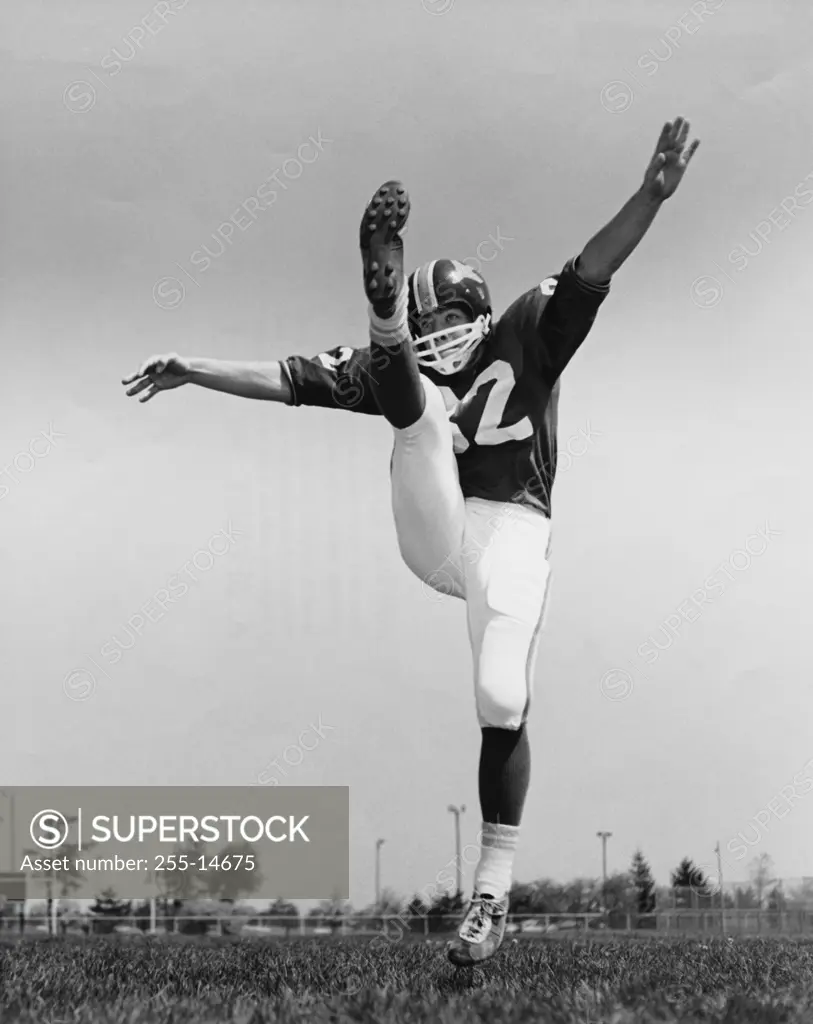 Low angle view of a football player kicking