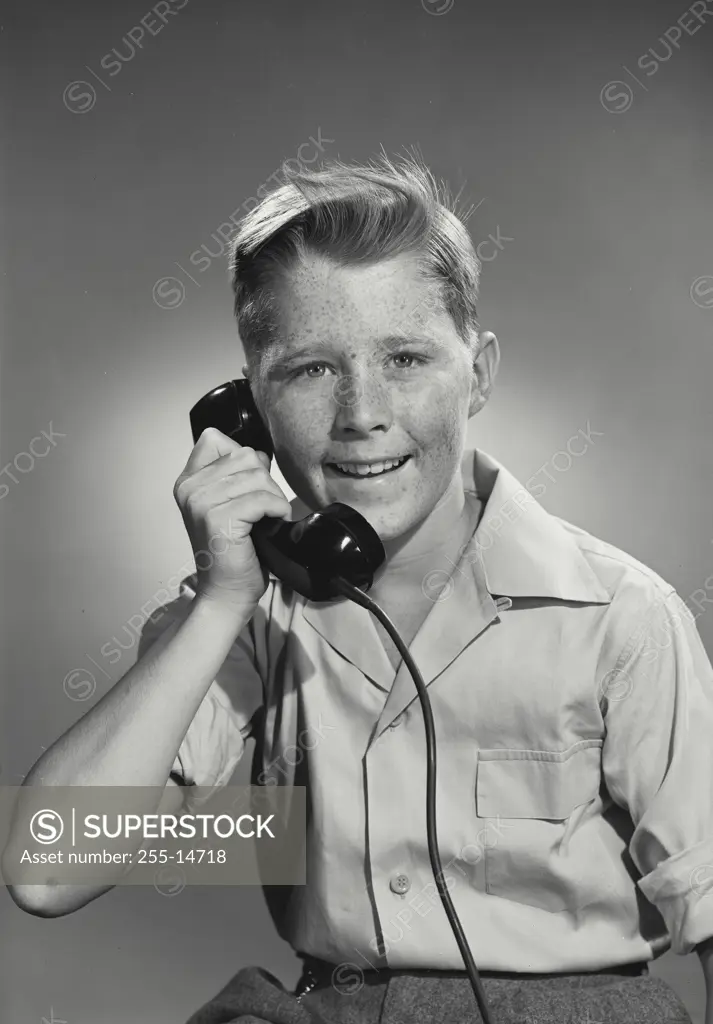 Vintage Photograph. Boy wearing button up shirt holding telephone reciever