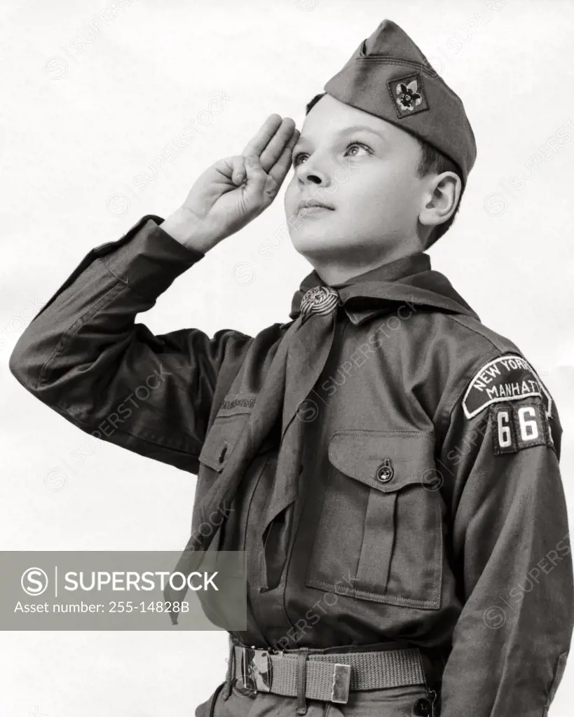 Close-up of a boy scout saluting