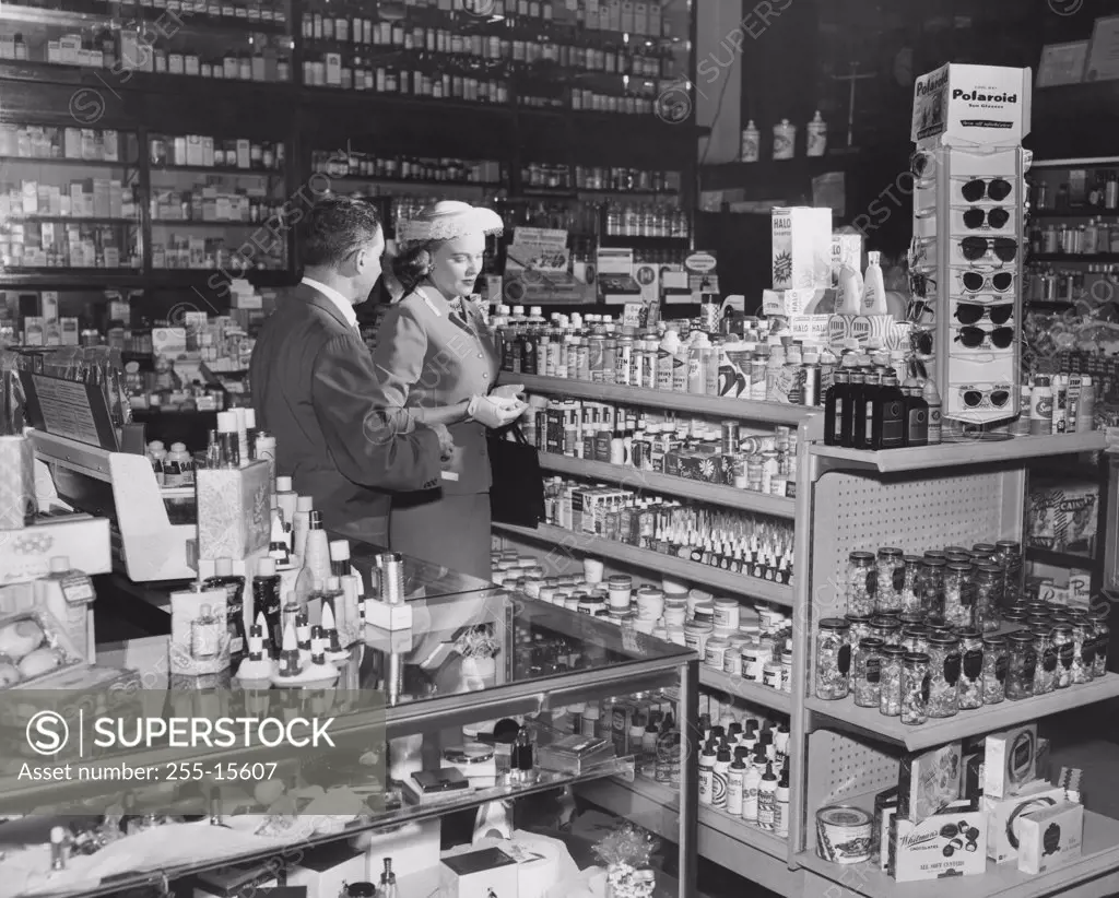 Side profile of a salesman standing with a customer in a store