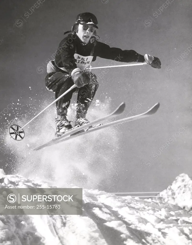 Low angle view of a young man skiing downhill