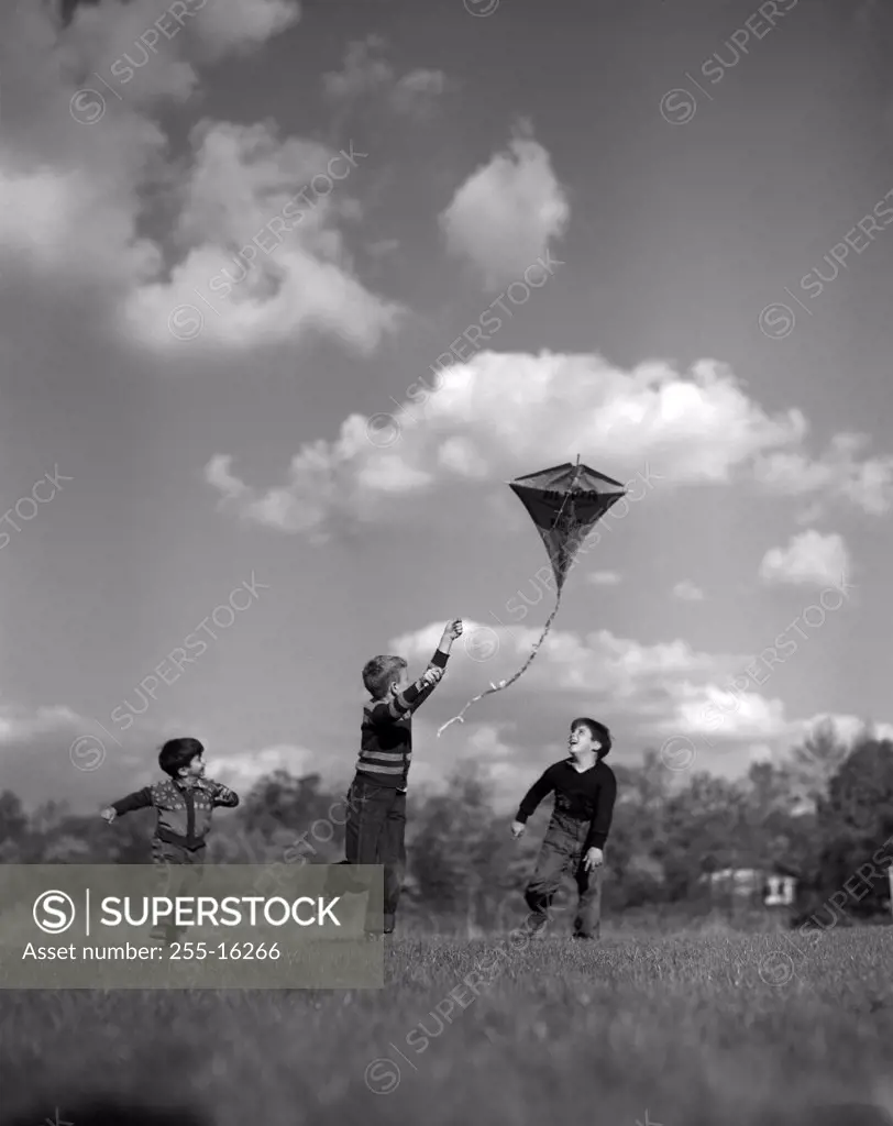 Vintage photograph of children playing with kite