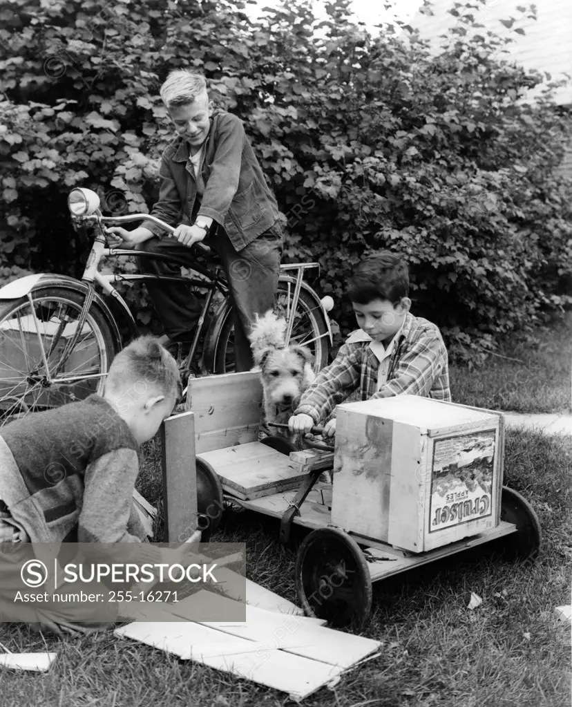 Vintage photograph of boys making gocart