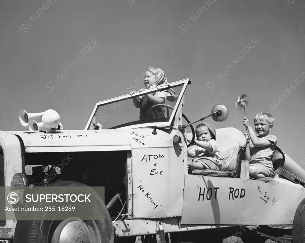 Side profile of three children sitting in a car