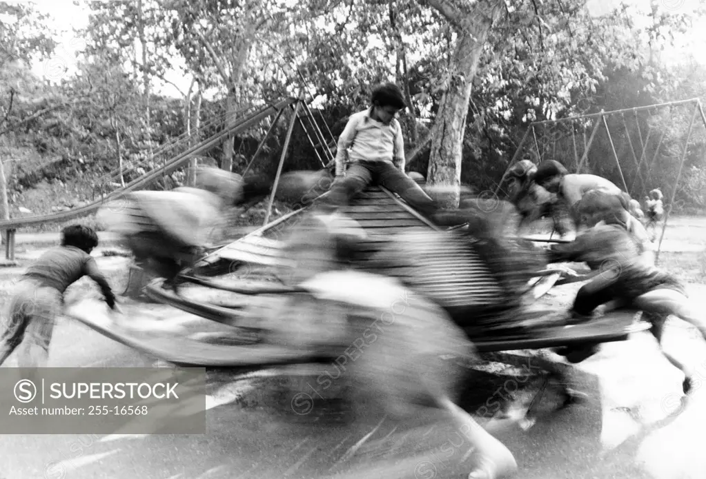 Children on spinning merry-go-round