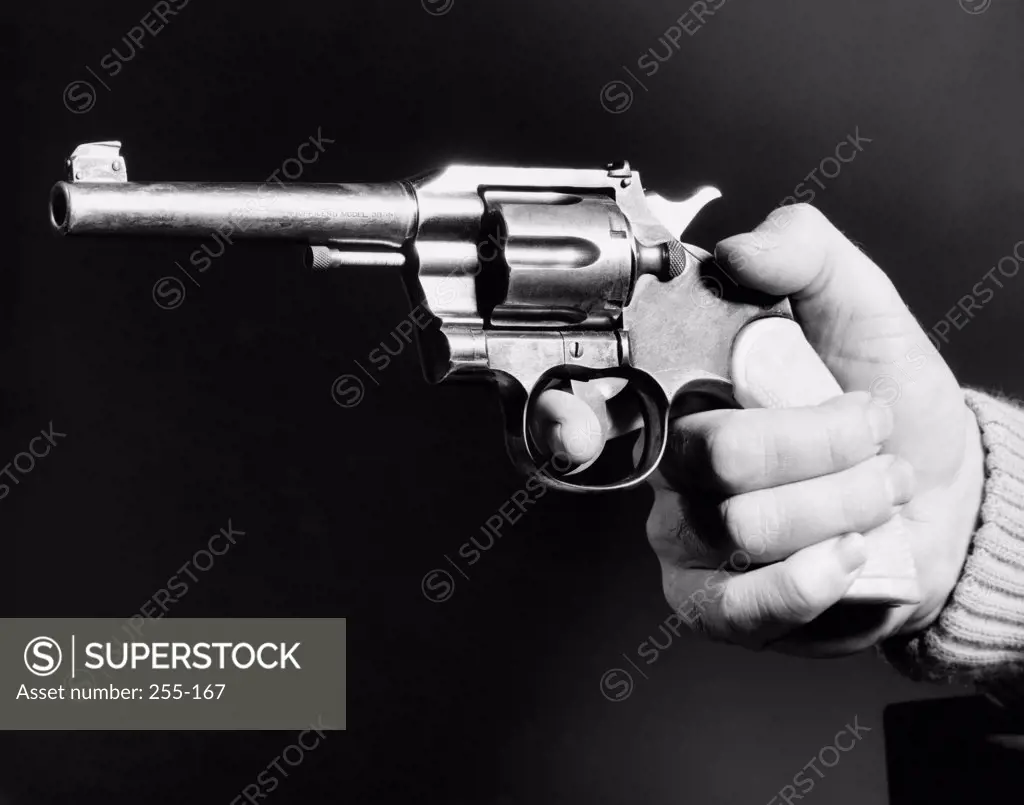 Close-up of a man's hand holding a revolver