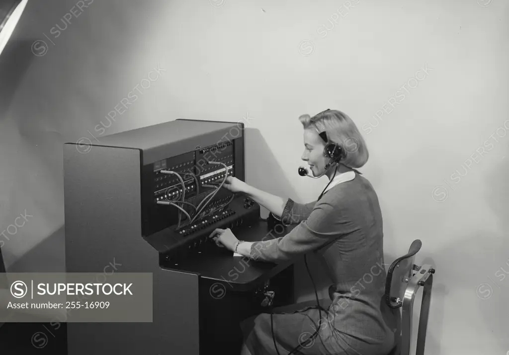 Vintage Photograph. Blonde woman switchboard operator smiling wearing headset, Frame 2