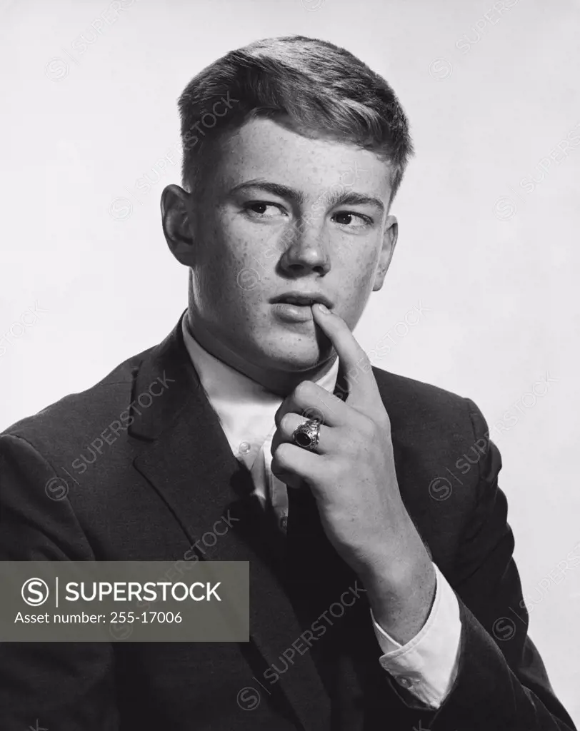 Close-up of a teenage boy thinking