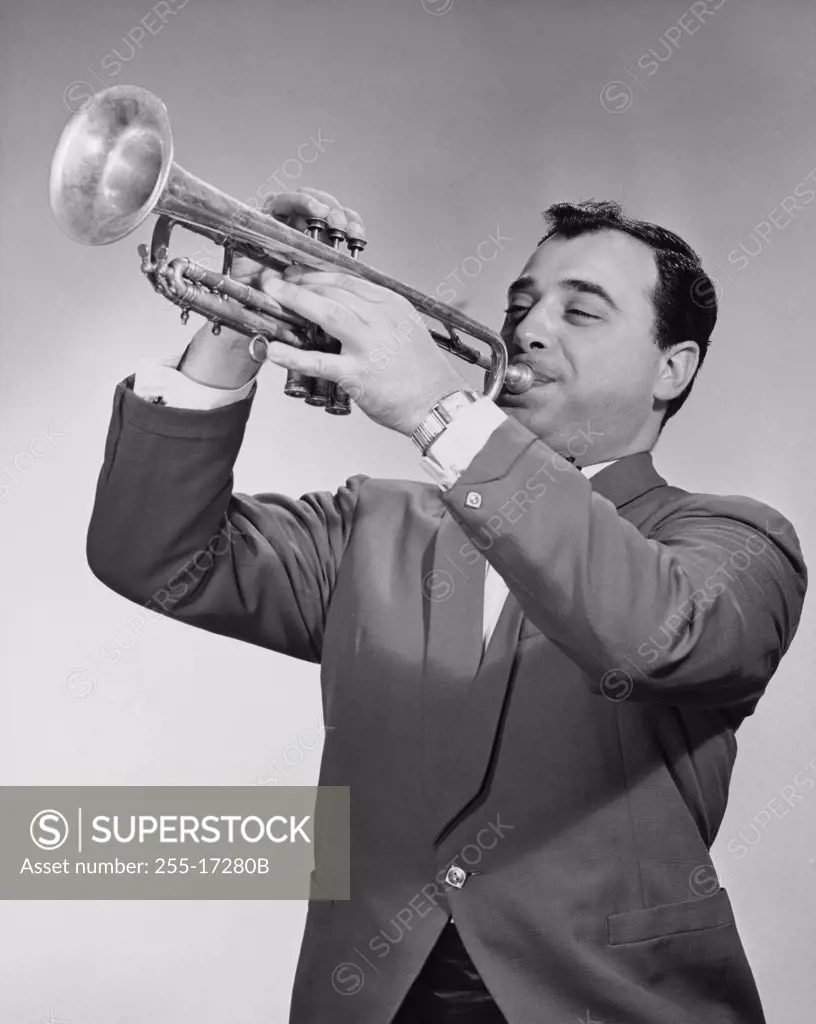 Mid adult man playing a trumpet