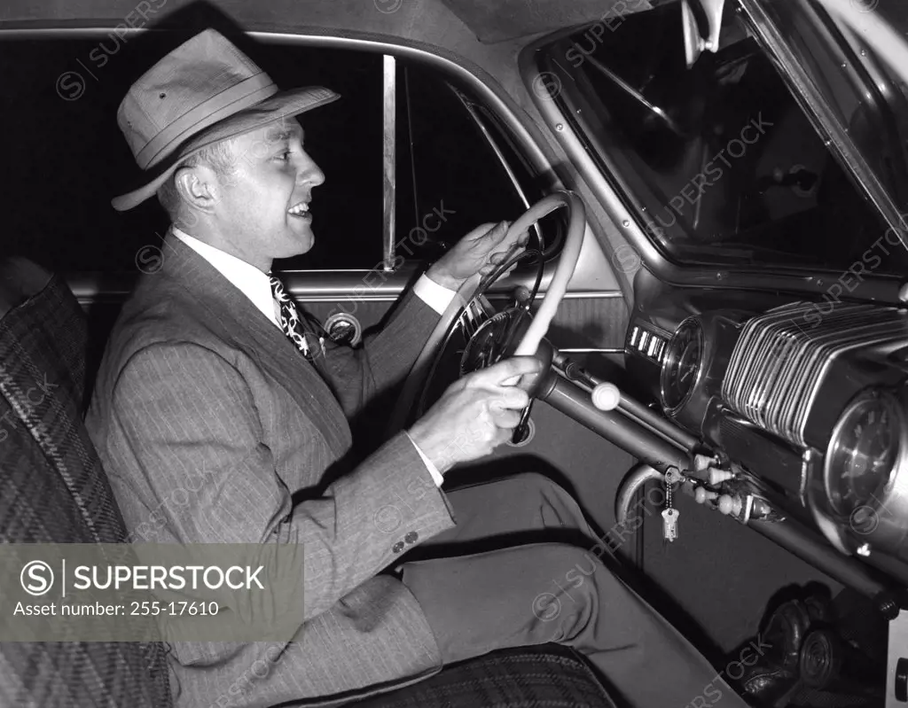 Side view of mature man sitting inside of car