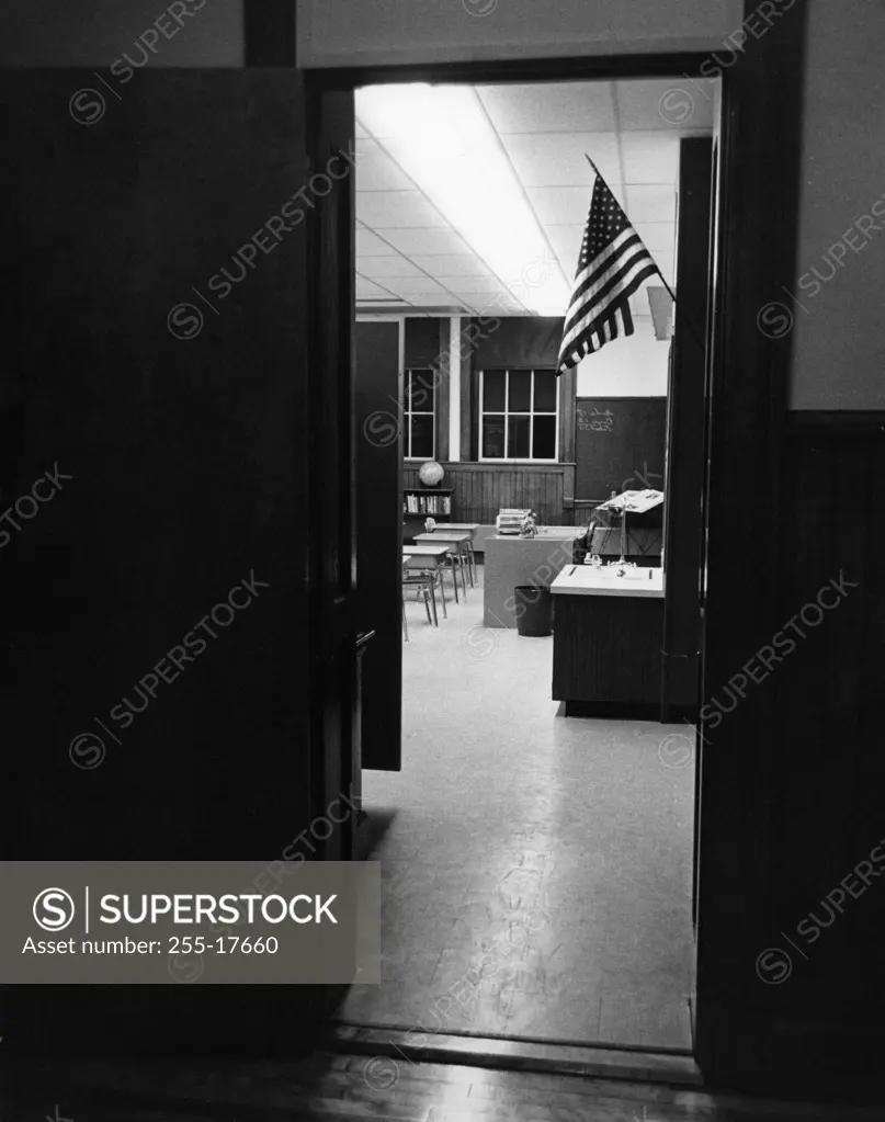 American flag seen from the door of a classroom