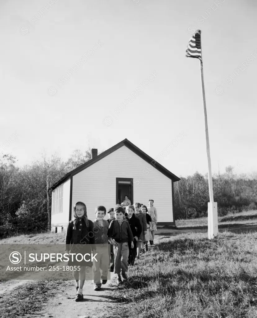 School children walking out of their school building, Massachusetts, USA