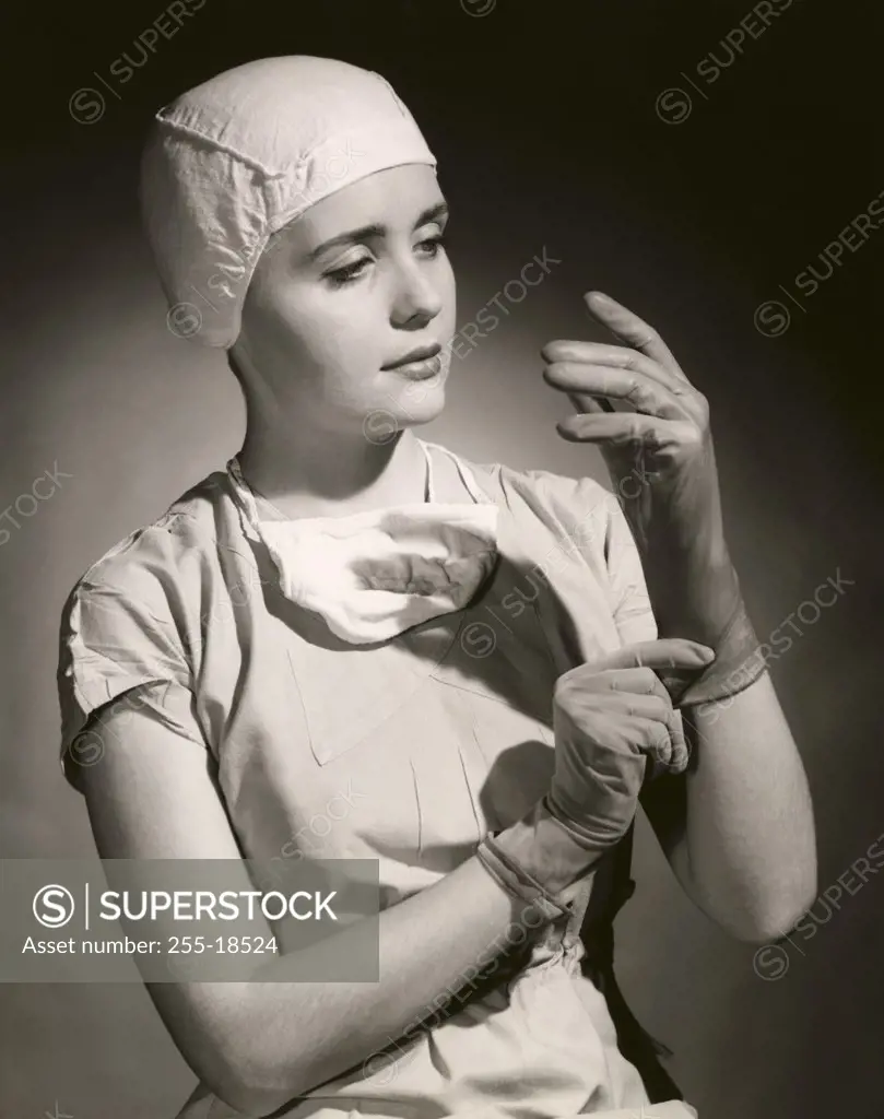 Close-up of a female nurse wearing surgical gloves