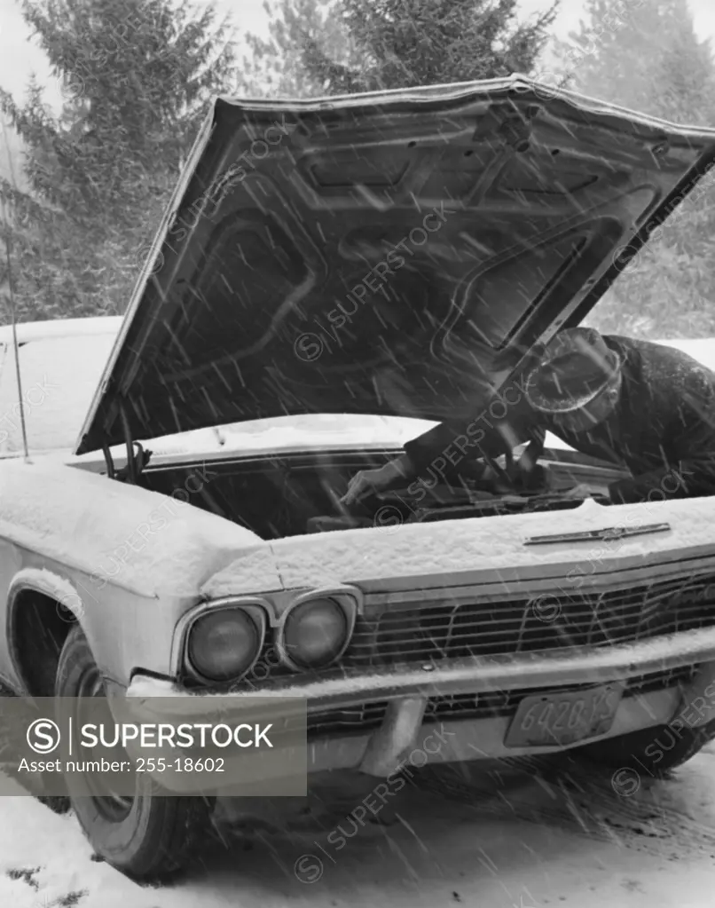 Auto mechanic repairing a vintage car