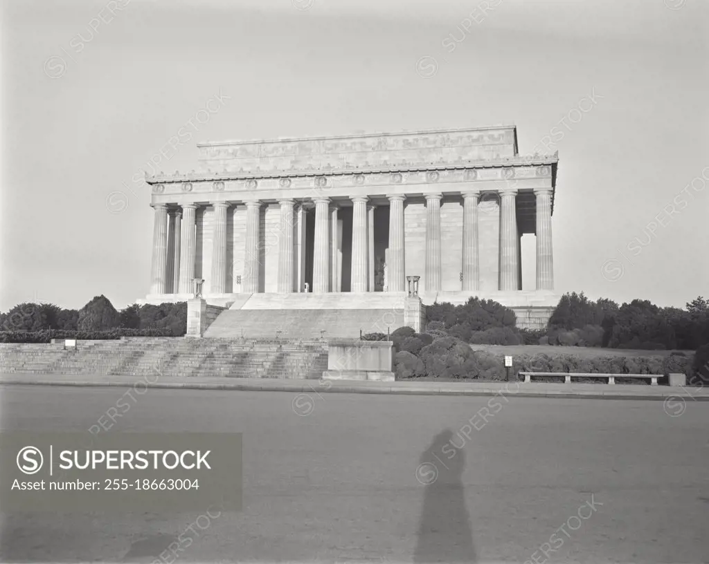 Vintage photograph. Sunrise scene, closed Lincoln Memorial, photographer's shadow in foreground.