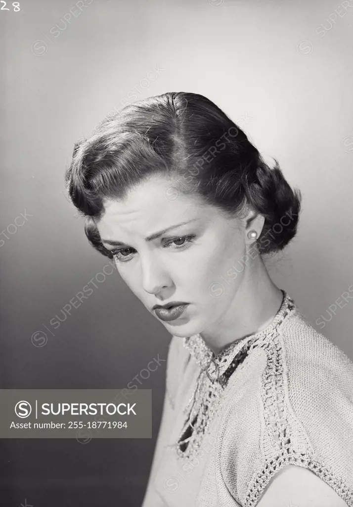 Vintage photograph. Portrait of young woman looking sad. Model released