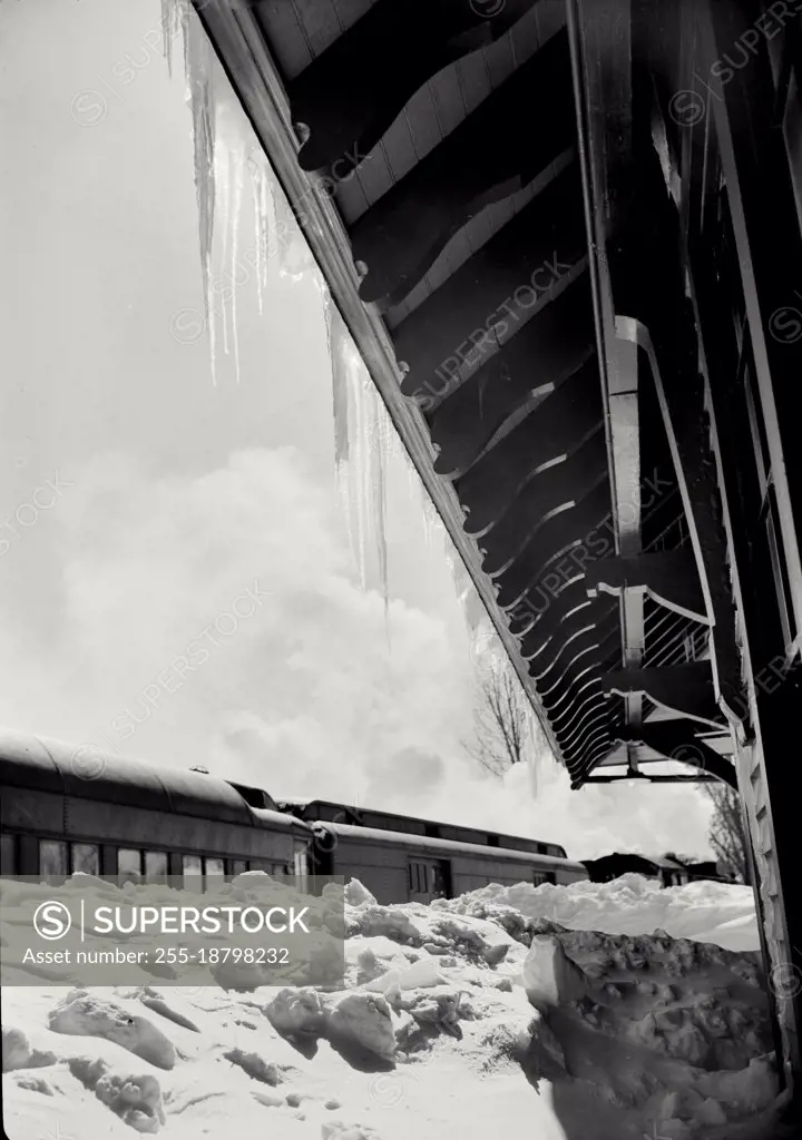 Vintage photograph. View of icicles hanging off house in winter