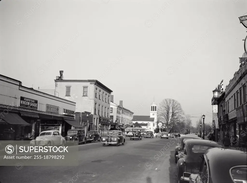 Vintage photograph. Busy street scene with vintage cars in Hempstead, Long Island, New York