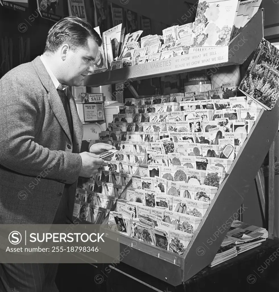 Vintage photograph. Man buying seeds in store, model released