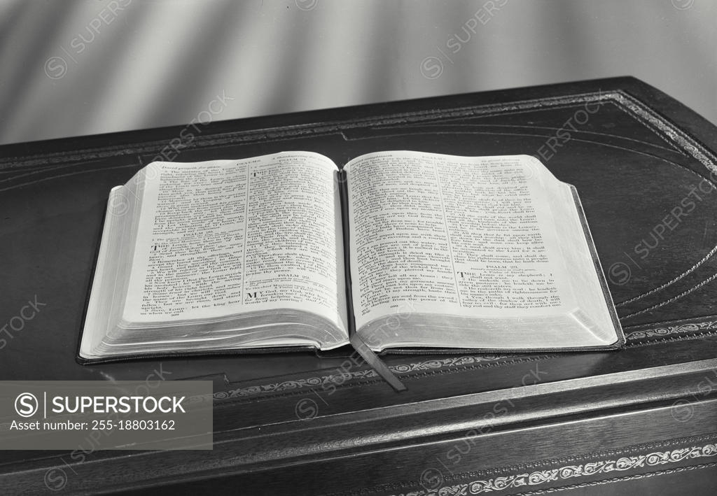 Vintage photograph. Holy bible sitting open on desk - SuperStock