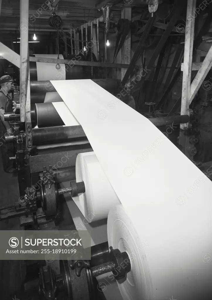 Vintage photograph. View showing a coating operation of a paper machine