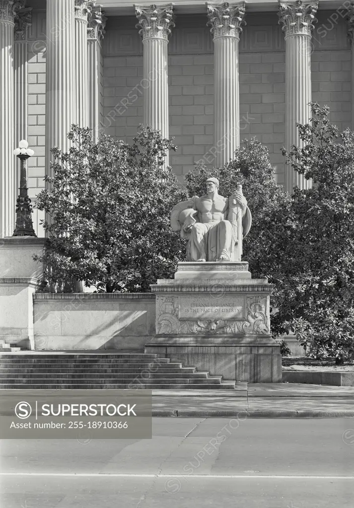 Vintage photograph. Statue in front of the National Archives Building