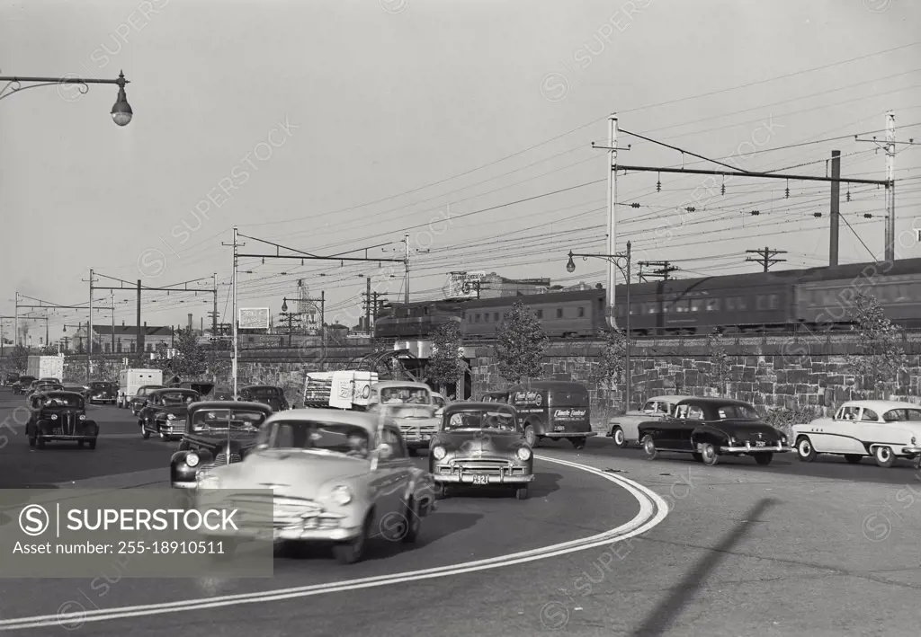 Vintage photograph. Cars driving on road in Newark