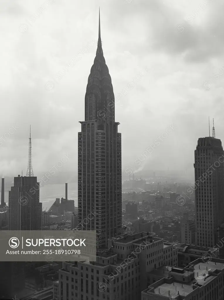 Vintage photograph. Looking south east across Mid Town Manhattan with Chrysler Building in center and Daily News Building on the left with television transmitting antenna on its roof