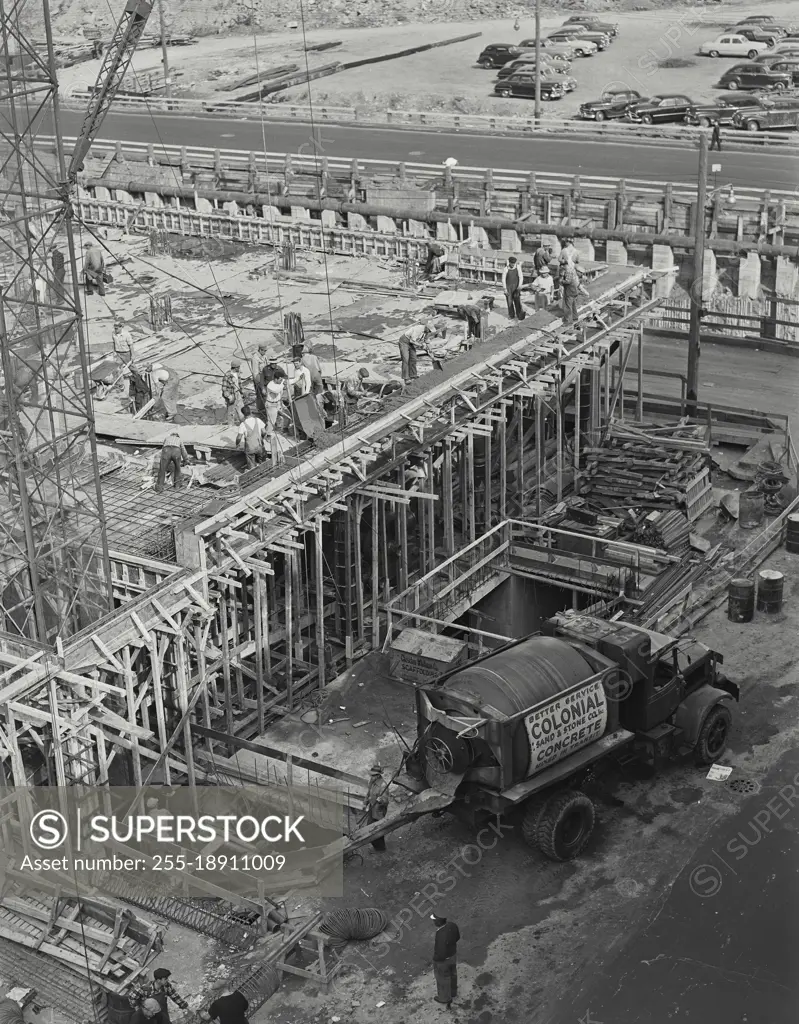 Vintage photograph. Truck pouring concrete at construction site.