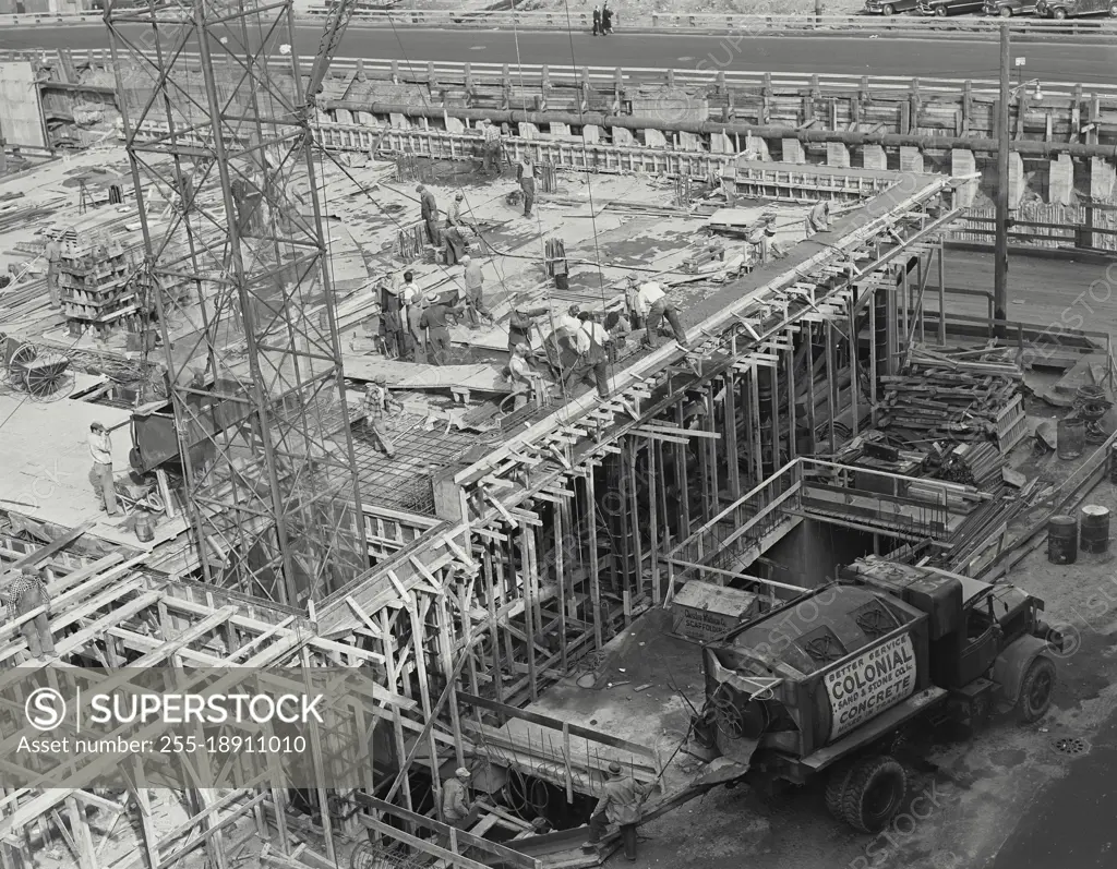 Vintage photograph. Truck pouring concrete at construction site.